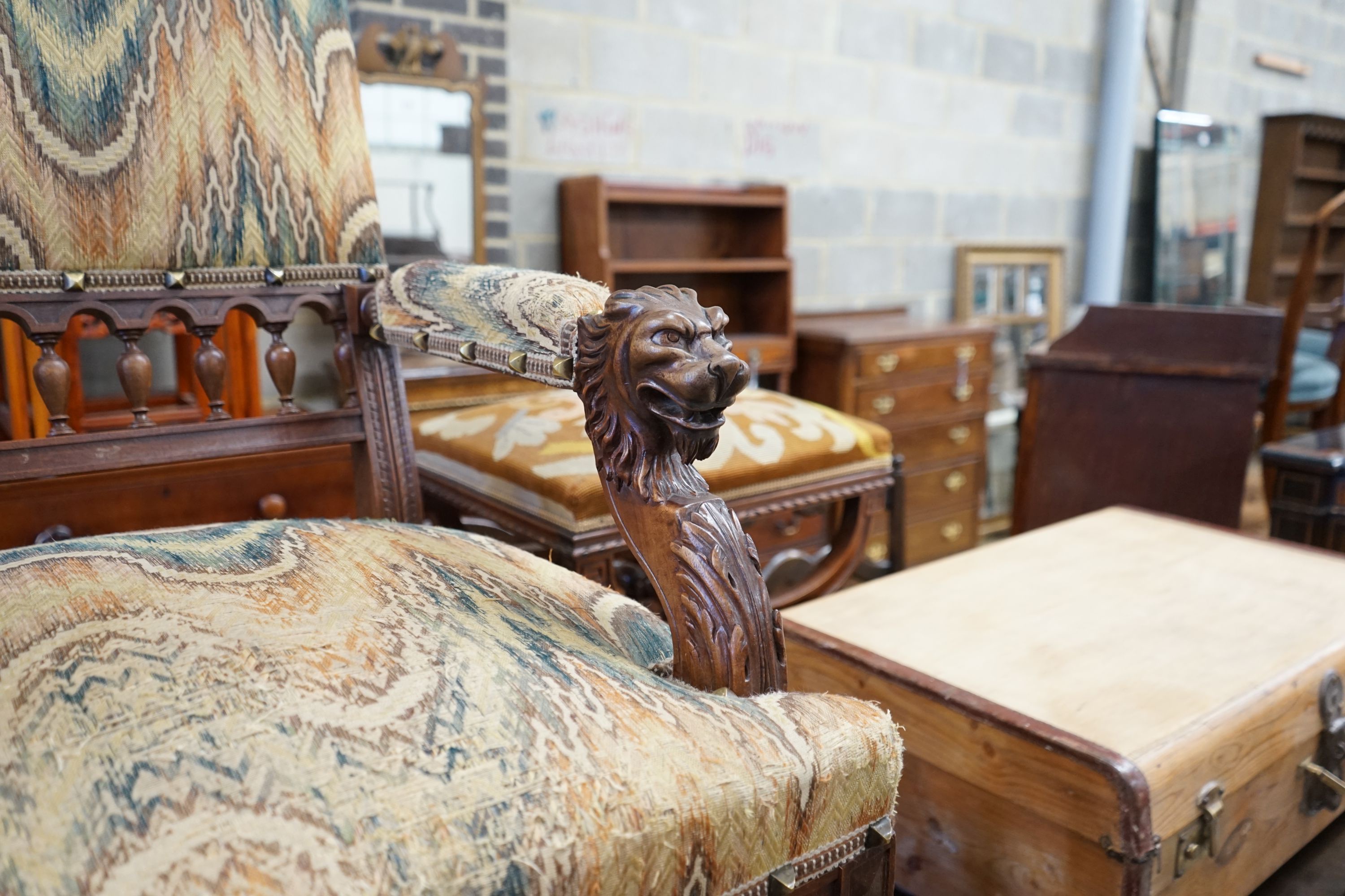 An early 20th century French walnut elbow chair with carved lion head arms, width 63cm, depth 60cm, height 106cm